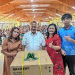 Dr. Hendri Tumbur Simamora, S.E. M.Si (tengah) didampingi istrinya Astilda Sinabutar (pertama kanan), dan anaknya (kedua kanan) menyerahkan hadiah door prize